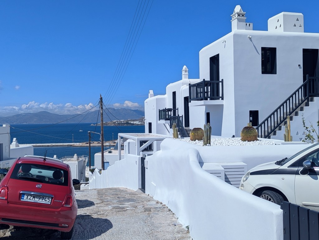 Straight out of a postcard—Mykonos charm in white, wood, and cactus green